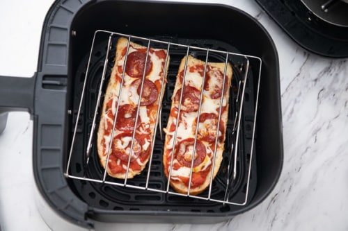 Cooked pizzas with a wire rack over the top