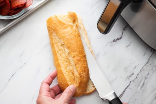 Slicing French bread loaf