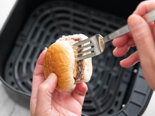 Separating top bun from slider with a fork