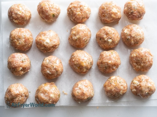 Meatballs formed and sitting on a board