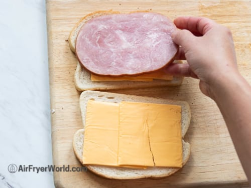 Assembling ham and cheese sandwich