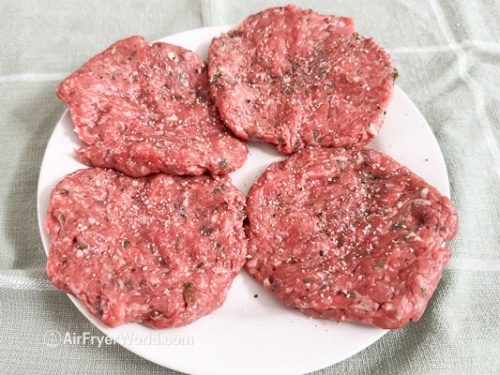 salt and pepper on lamb burgers