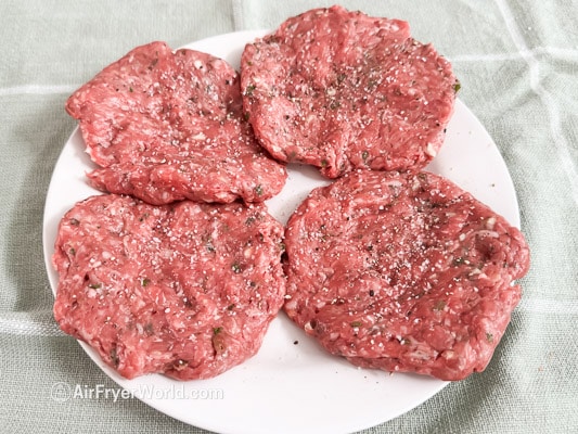 salt and pepper on lamb burgers