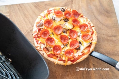 Lifting the pizza out of the air fryer