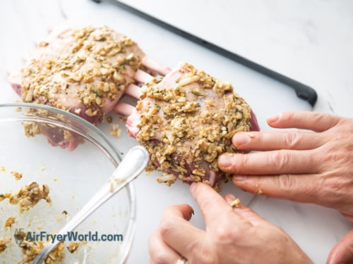 Pressing parmesan crust onto lamb