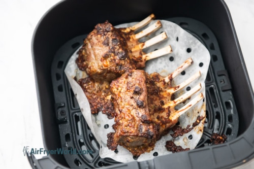 Fully cooked crusted lamb rack in air fryer basket