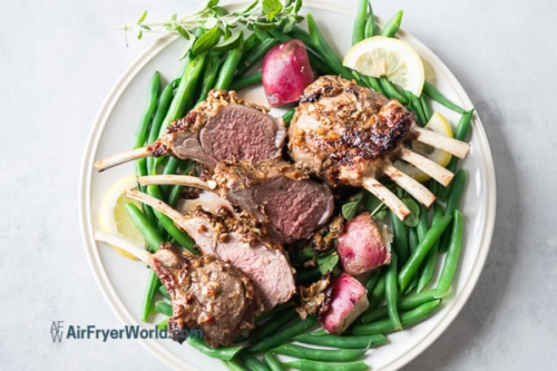 Cut lamb chops on a plate with vegetables