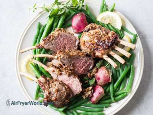 Cut lamb chops on a plate with vegetables