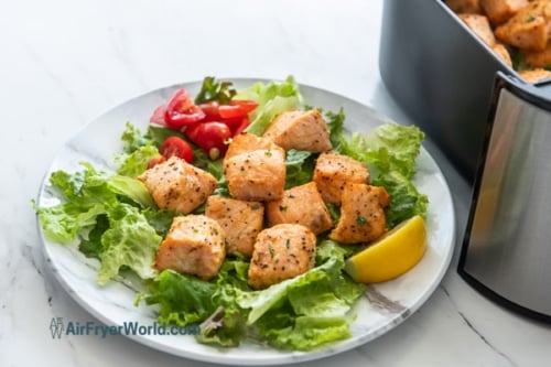 plated dish of salmon bites on salad