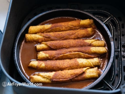 Taquitos cooked with sauce over the top