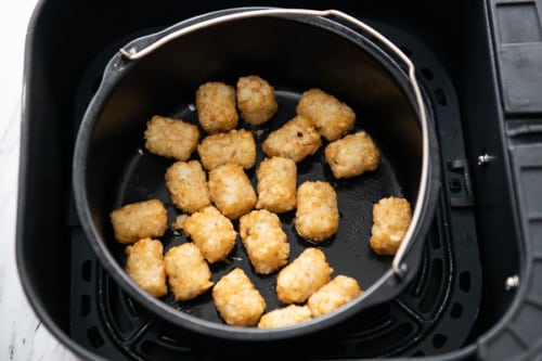 Cooked tater tots in the baking bucket