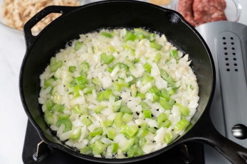Onions and celery cooking in a skillet