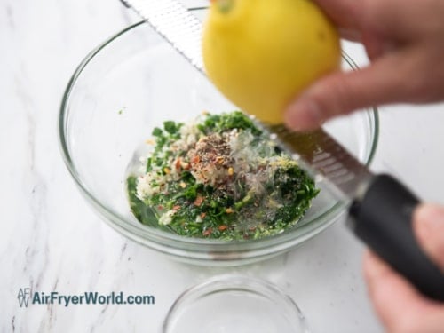 zesting lemon juice into sauce bowl