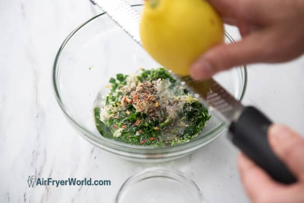 zesting lemon juice into sauce bowl
