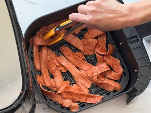 laying flat the hot dog strips