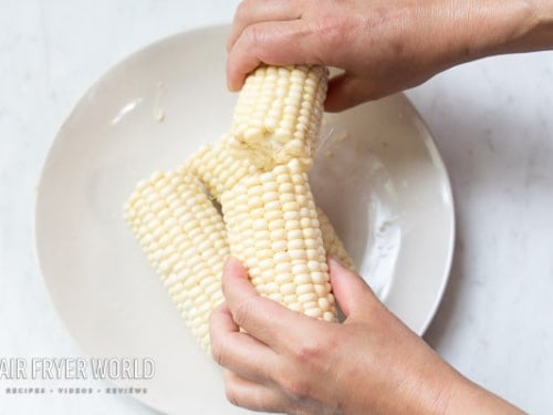 Breaking corn in half