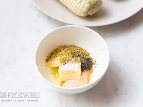 Softened butter with lemon pepper seasoning in a bowl