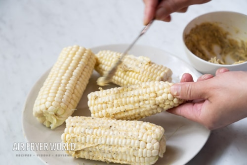 Coating corn with seasoned butter