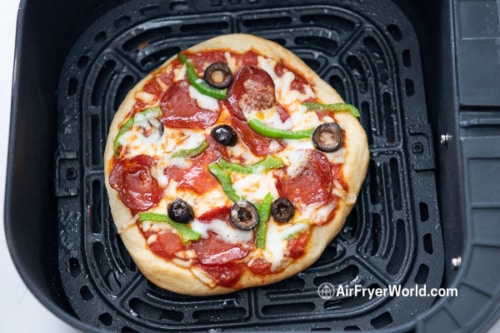 Cooked pizza in air fryer basket