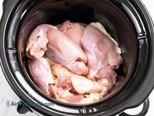 raw chicken in the slow cooker pot
