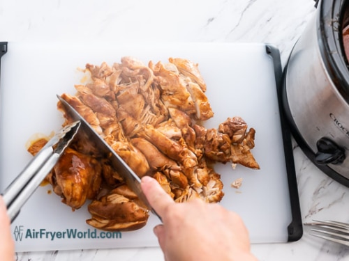 cutting the cooked taco chicken