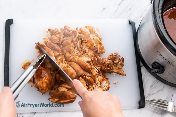 cutting the cooked taco chicken